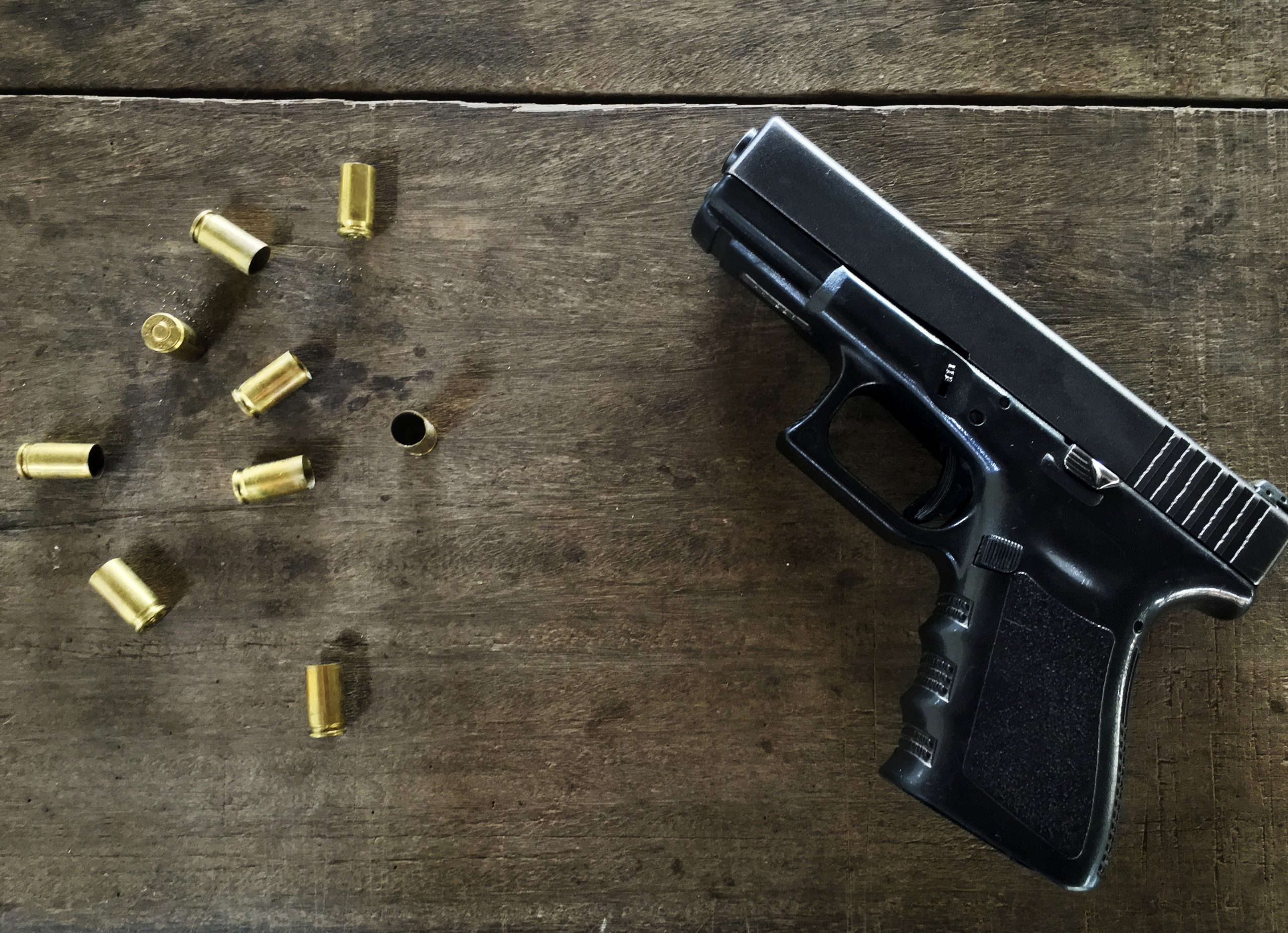 Empty bullets and a gun on at table